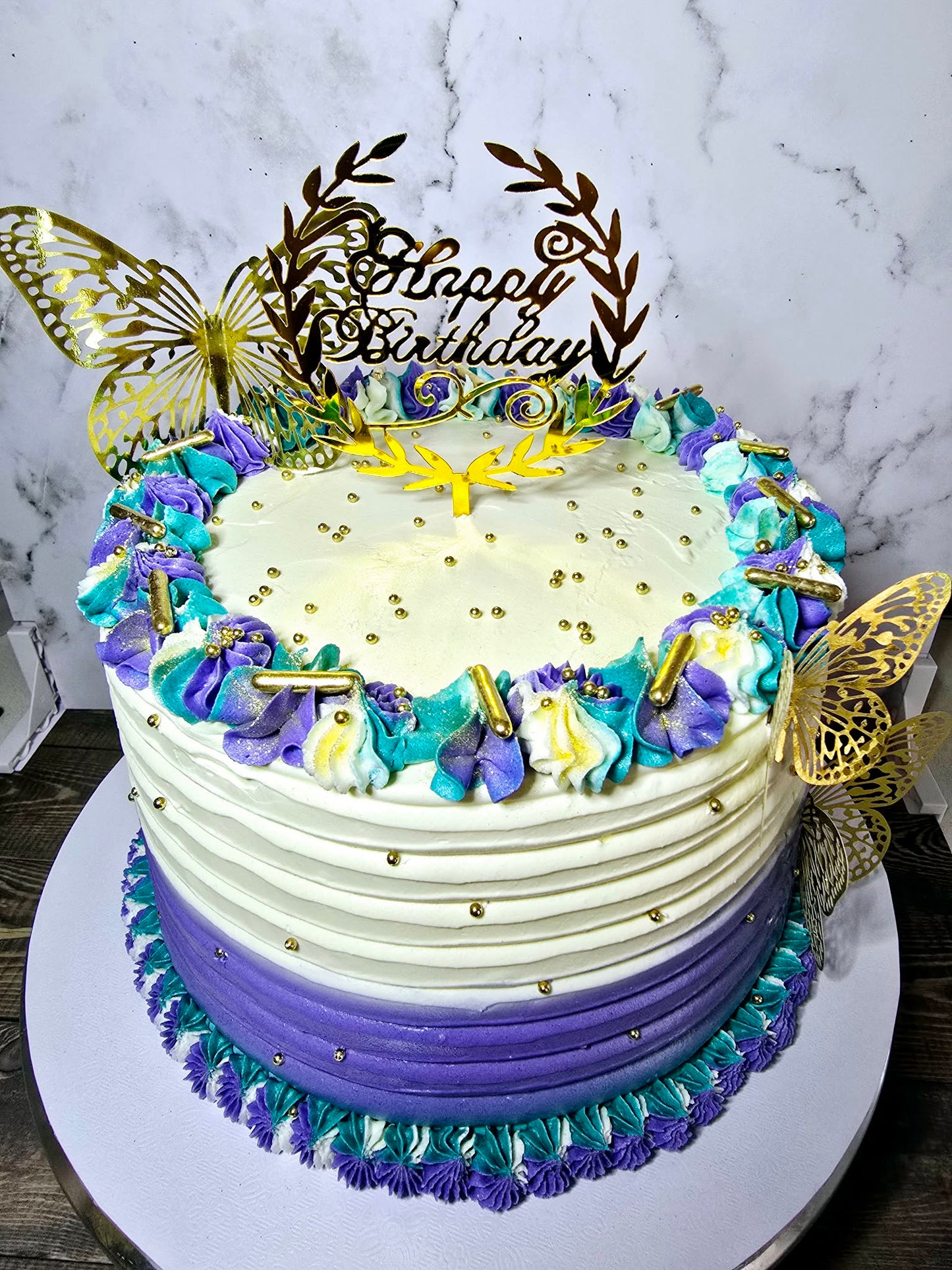 White, purple and teal cake with butterflies