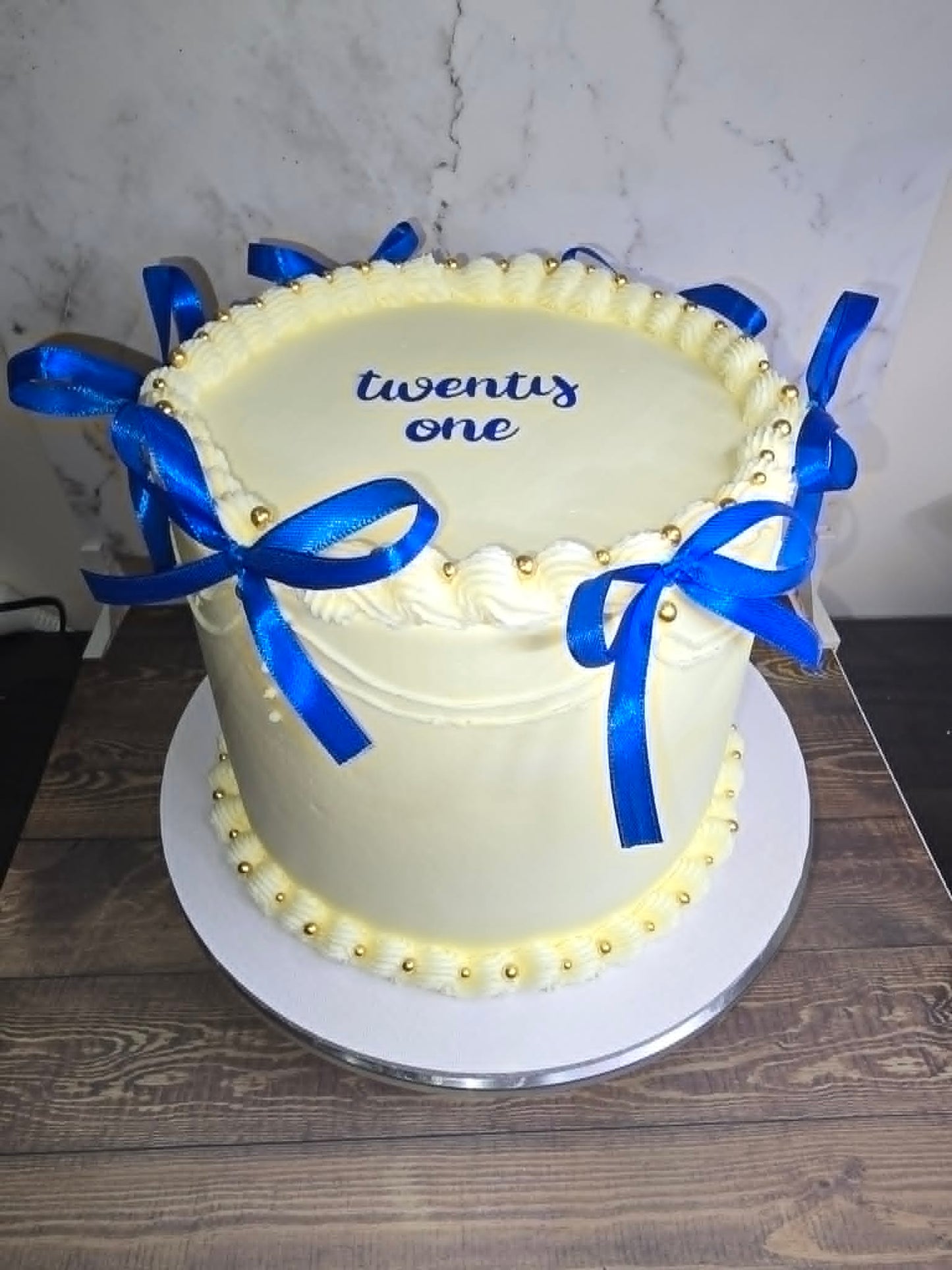 White cake with blue ribbon