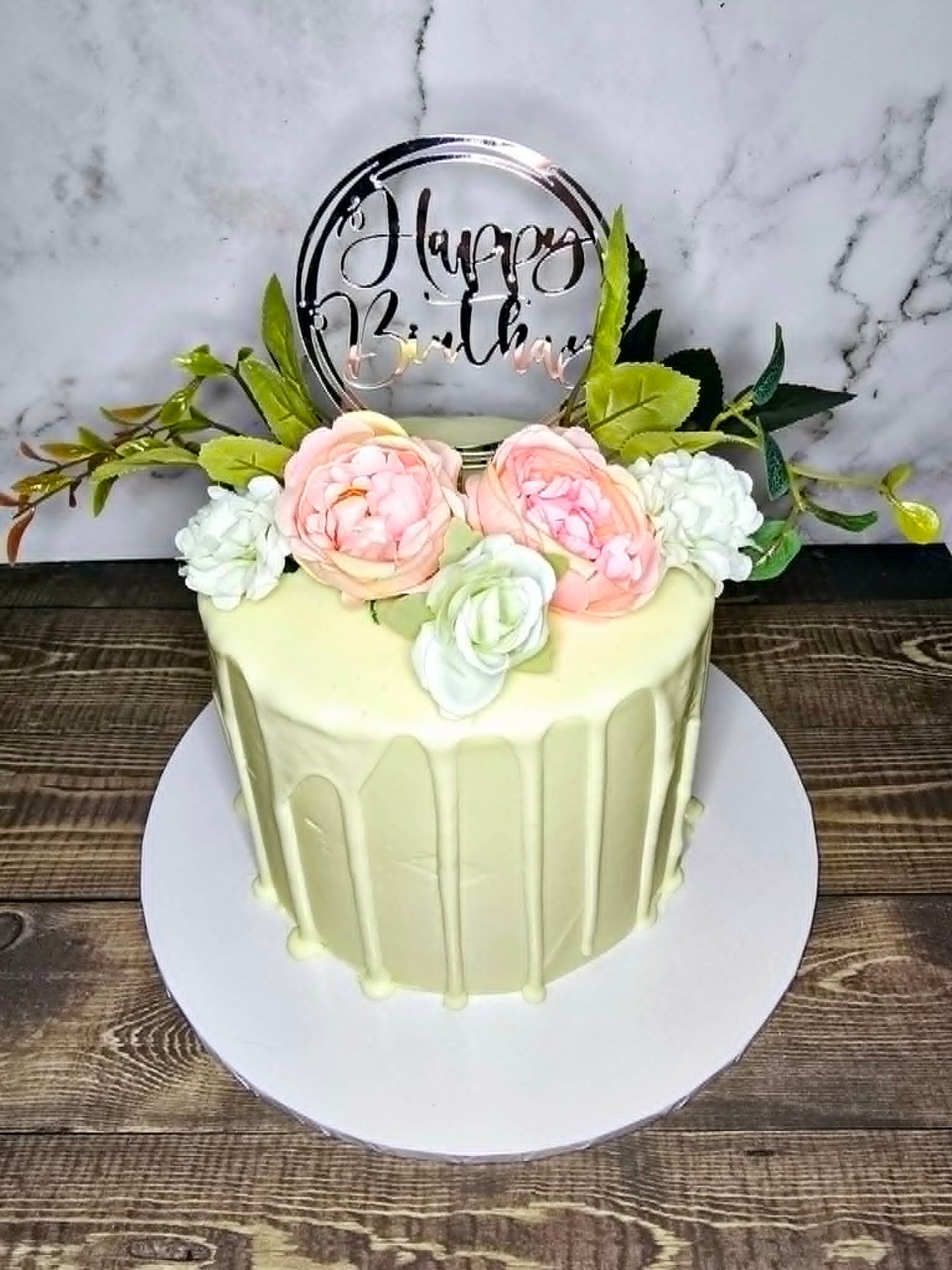 White Cake with White Chocolate Drip, Flowers and Happy Birthday Topper
