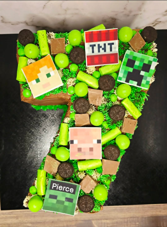 Number 7 shaped cake with Minecraft-themed decorations on a green background