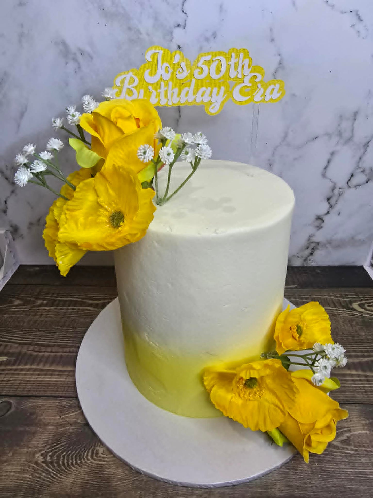 White cake with yellow flowers.