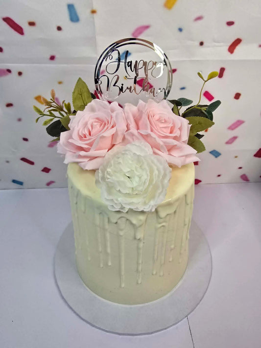 White Cake with White Chocolate Drip, Flowers and Happy Birthday Topper