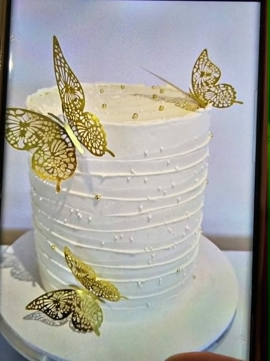 White Cake with gold sugar balls and gold plastic butterflies